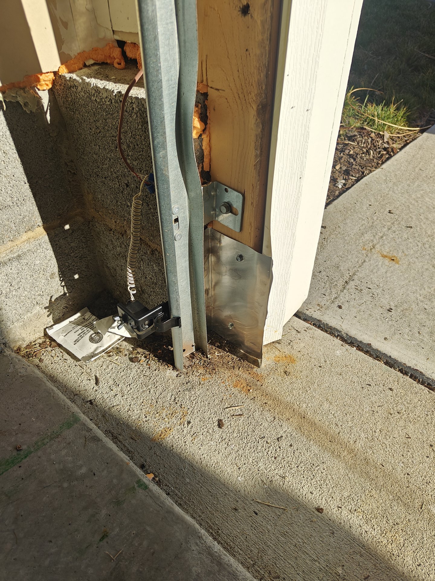 Garage door jamb showing a rodent entry point